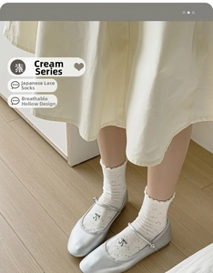 Close-up of cream bow socks with hollow-out texture and lace edges for women