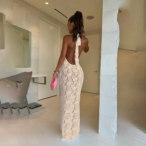 Macro view of detailed lace fabric and backless tie design on the elegant white dress