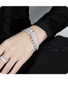 Macro shot of silver S925 ruffle cuff bracelet and matching ring on model hand
