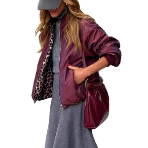 Detail of reversible burgundy satin bomber jacket with leopard print lining and zipper