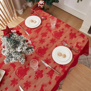 Détail d'une nappe de Noël rouge festive avec motifs de rennes et de flocons de neige