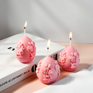 Detailed relief of pink egg-shaped candles with intricate rose flower carvings