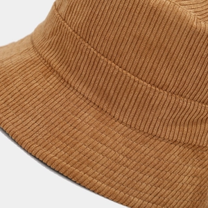 Close-up of brown corduroy bucket hat showing detailed vertical striped fabric texture