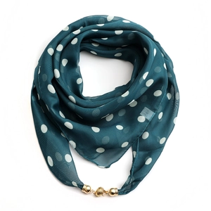 Detail of 100% silk dark teal polka dot scarf featuring a golden magnetic ball buckle