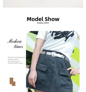 Detail of silver metallic pin buckle belt paired with a black skirt and white printed tee