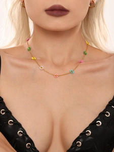 Close-up of handmade colorful bead flower necklace and golden metal chain on model