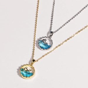 Elegant gold and silver whale pendant necklaces with blue ocean wave resin detailing