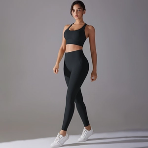 Detail of high-stretch matte black yoga set featuring racerback bra and high-waist leggings