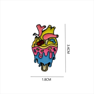 Macro view of anatomical heart ice cream enamel pin showing 3.4cm x 1.8cm dimensions