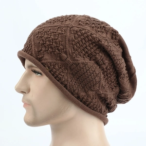 Detailed close-up of brown knit beanie featuring intricate hollow diamond crochet patterns
