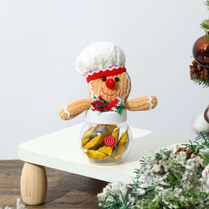 Close-up of gingerbread man plush jar for Christmas party treats on wooden stand
