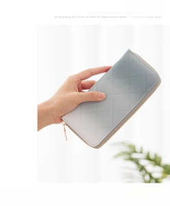 Detailed view of grey gradient quilted long wallet with golden zipper and luxury finish