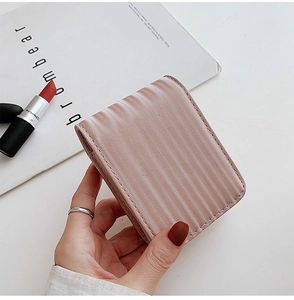 Mini pleated leather lipstick pouch in dusty pink with interior mirror for travel