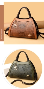 Detail of brown and dark green crocodile embossed leather bags with golden kangaroo hardware