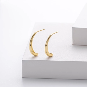 Close-up of golden S925 sterling silver petal earrings showing sharp detail and metal texture