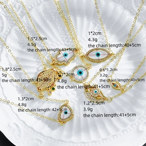 Golden evil eye necklace collection featuring mother of pearl and zircon crystal pendants
