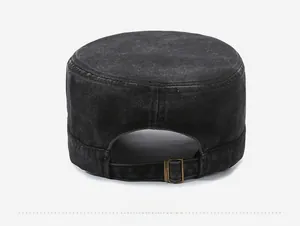 Detail of adjustable metal buckle and washed denim texture on military flat cap back