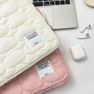 Quilted cloud texture detail on cream and pink iPad cases with zip closure