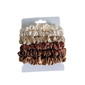 Set of 4 high-elasticity satin scrunchies in gradient neutral colors on display card