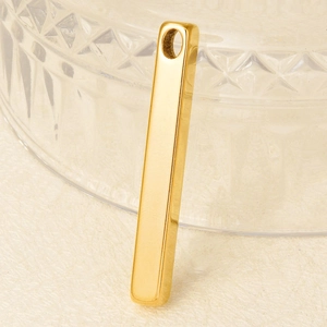 Minimalist 304 stainless steel gold bar pendant with polished finish on a beige background