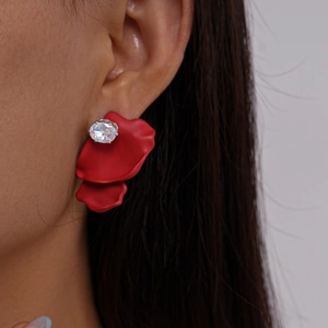 Detail of red petal stud earring with sparkling round zircon stone on model