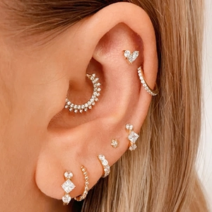 S925 sterling silver heart earrings set with sparkling cubic zirconia on female model ear