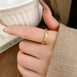 Detail showing colorful zircon star inlay and gold-plated starburst engraving on ring