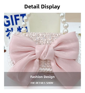 Detail of pink tweed girl's bag with silk bow, lace trim and pearl handle accents