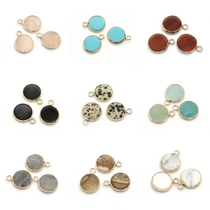 Macro view showing various natural stone round pendants with gold-plated ring settings
