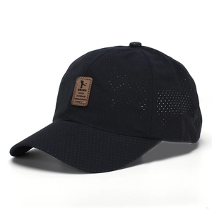 Detail view of breathable mesh fabric and brown leather patch on a black sport cap