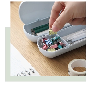 Close-up of white double-layer plastic pencil case with internal divider storage