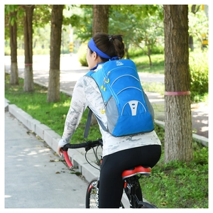 Outdoor cycling backpack with reflective strips worn by a cyclist on a scenic path