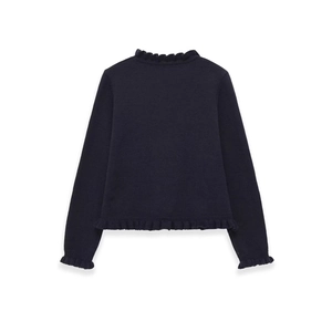 Detail of navy knit sweater featuring ruffled edges on the hem and sleeve cuffs