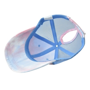 Detail view of tie-dye ponytail sun hat showing breathable mesh and 100% cotton wash label