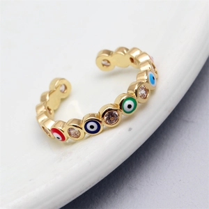 Macro shot of evil eye adjustable ring with colorful enamel and cubic zirconia stones