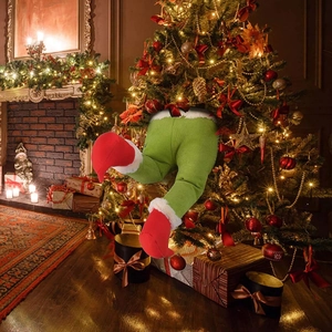Christmas tree decoration featuring green striped elf legs with red shoes and white plush