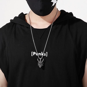 Retro stainless steel horned demon face necklace for men on a black shirt model