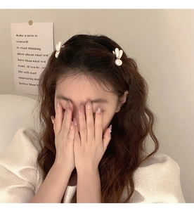 Close-up of elegant pearl bunny ear hair clips worn by a model in a sweet daily style