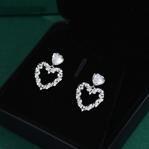 Exquisite S925 silver heart stud earrings with sparkling white zircons in a jewelry box