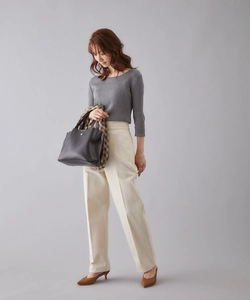 Business casual outfit with grey knit top, cream trousers and black leather handbag