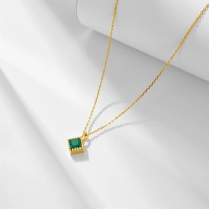 Detail of a square green zircon pendant on a gold sterling silver chain necklace