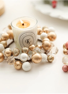 Detail of champagne gold and white pearl Christmas wreath candle holder with beads