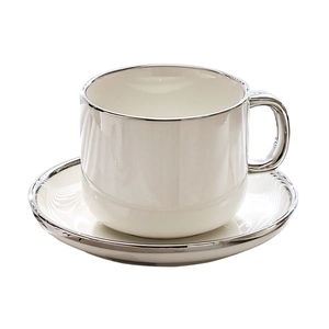 Elegant white ceramic coffee cup and saucer set with silver trim on a clean white background