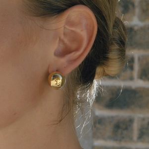 Minimalist high-polished gold hollow ball stud earrings worn by a model for a luxury look