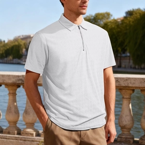 Men's white polo shirt with quarter-zip and woven texture in an outdoor setting