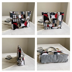 Detail view of ethnic canvas tote bag with abstract geometric print and grey handles