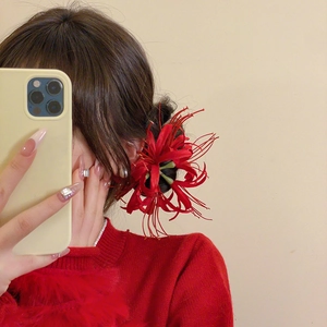 Elegant red Lycoris hair clip shown on model for a classic New Year traditional style