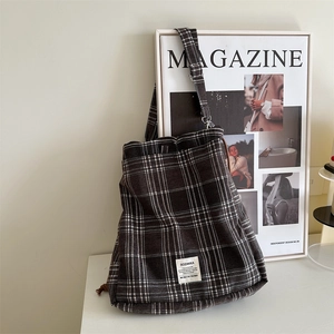 Detail view of large plaid canvas tote bag with SOZAKKA label and durable shoulder strap