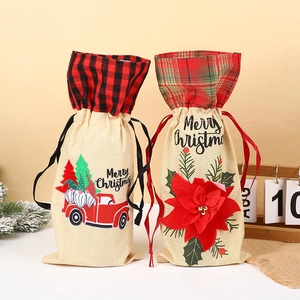Detail of linen Christmas wine bottle gift bags with drawstring and festive patterns