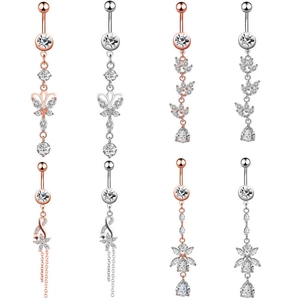 Macro shot of assorted zircon belly button rings in rose gold and silver finishes